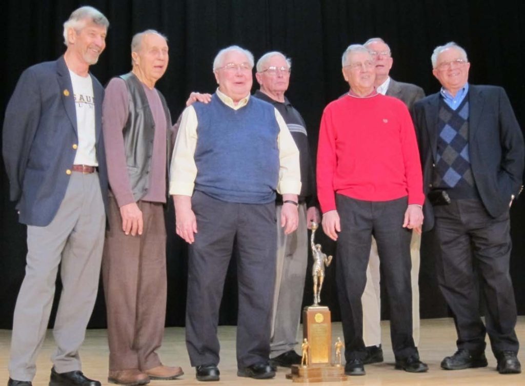 A group of older negaunee basketball players.